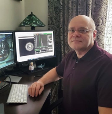 Vitali Prakapenka, sitting at a computer.