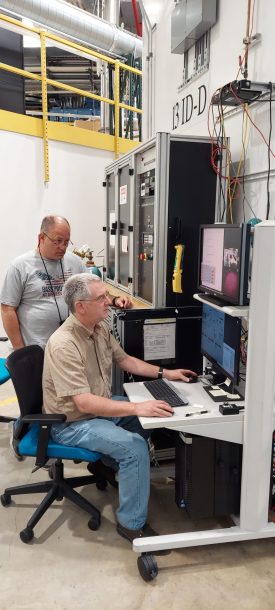 Richard A. Ferry and Curtis A. Kenney-Benson loading DACs.